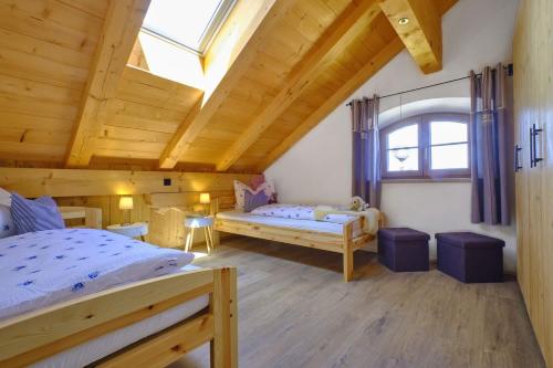 a bedroom with a bed and a window at Huberhof Hinzing Ferienbauernhof in Pittenhart