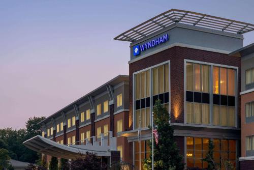 a hotel building with a sign on top of it at Wyndham Avon in Avon Center