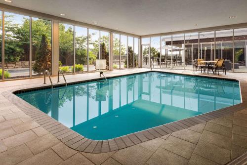 a swimming pool in a house with windows at Wyndham Avon in Avon Center