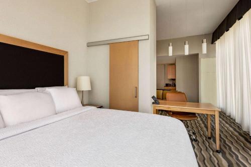 a hotel room with a large bed and a desk at Wyndham Avon in Avon Center