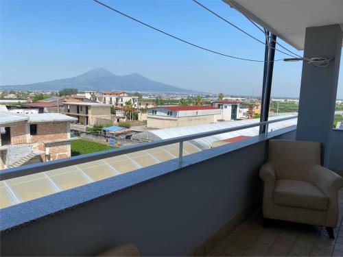 a balcony with a chair and a view of a city at Casa di Antonia in San Marzano sul Sarno