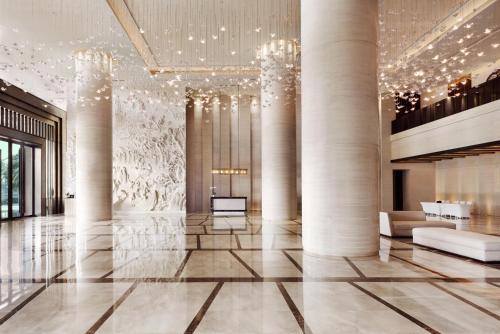 a lobby of a building with columns and chandeliers at The Westin Pazhou in Guangzhou