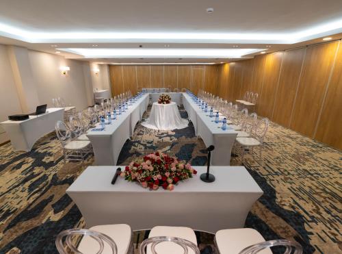 a conference room with rows of tables and chairs at Stay Easy Plus Hotel in Addis Ababa