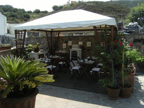 a restaurant with tables and chairs under a white canopy at Lunaponzese-Ponza centro in Ponza
