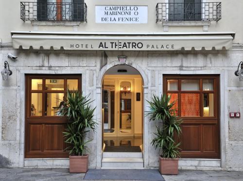 a hotelalloallo palace entrance with two doors and two plants at Al Theatro Palace in Venice