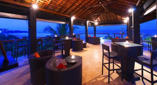 a restaurant with tables and chairs and a view of the ocean at Thaala Bentota in Bentota
