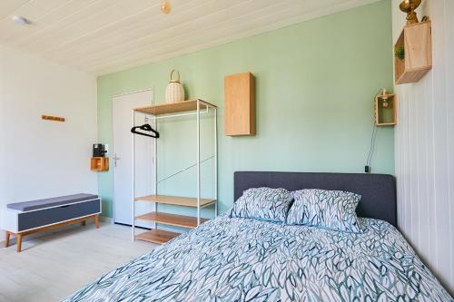 a bedroom with a bed and a book shelf at L'appartement in Pontarlier