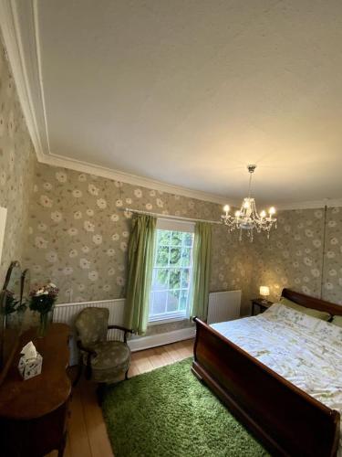 a bedroom with a large bed and a window at Creamore Grove Wem Shrewsbury in Wem