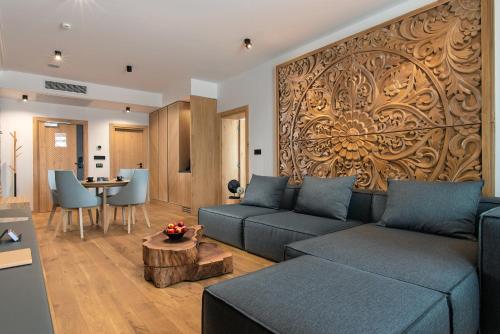 a living room with a couch and a table at Wine & SPA Hotel Chukara in Tryavna