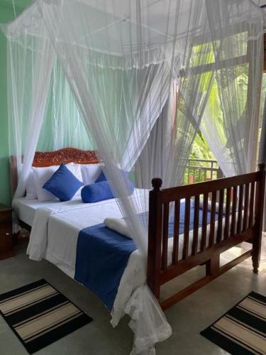 a bedroom with a bed with a canopy at Hermitage Villa in Kandy