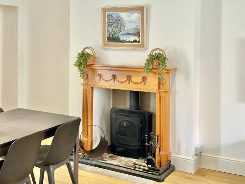 a fireplace in a dining room with a table and chairs at The Annex - central Helmsley with parking in Helmsley