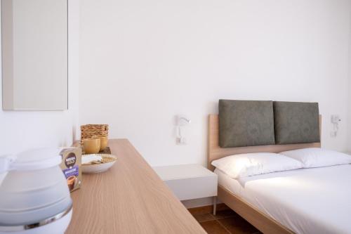 a bedroom with a bed and a table with a blender at Nautika Suites in Alghero