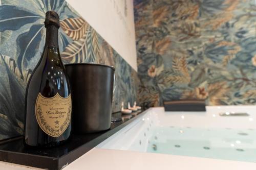 a bottle of wine sitting on a shelf with a bucket at Suites Matteotti 57 in Civitavecchia