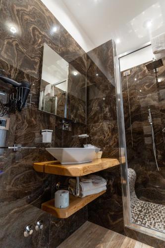a bathroom with a sink and a shower at Suites Matteotti 57 in Civitavecchia