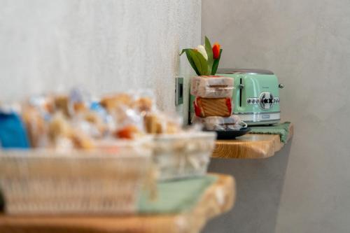 a toaster sitting on top of a table with food at Suites Matteotti 57 in Civitavecchia