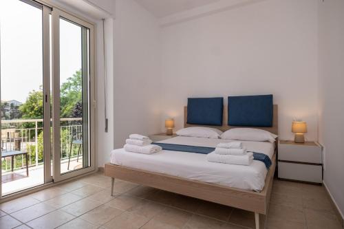 a bedroom with a bed with towels on it at Nautika Suites in Alghero