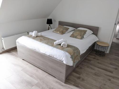 a bedroom with a large bed with white sheets and pillows at Maison moderne au cœur du Golfe du Morbihan ! in Plougoumelen