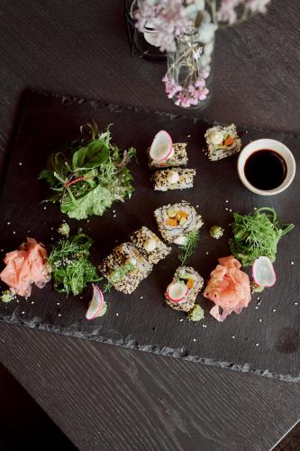 a plate of food with sushi on a table at SOULSISTERS' Hotel 4 Sterne Superior in Kaprun