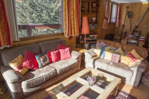 a living room with two couches and a coffee table at Luxury apartment near the slopes in Courchevel in Courchevel