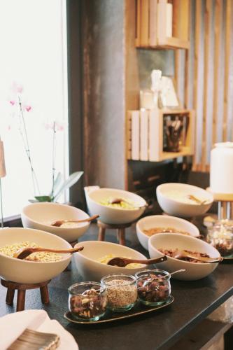 a table with bowls of food on top of it at SOULSISTERS' Hotel 4 Sterne Superior in Kaprun