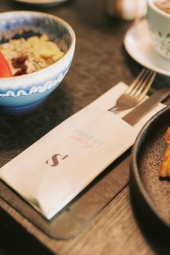 a table with a bowl of food and a napkin at SOULSISTERS' Hotel 4 Sterne Superior in Kaprun