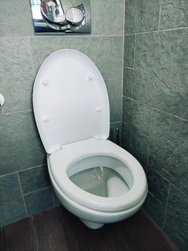 a bathroom with a toilet with the lid open at Antico Centro Quartu in Quartu SantʼElena