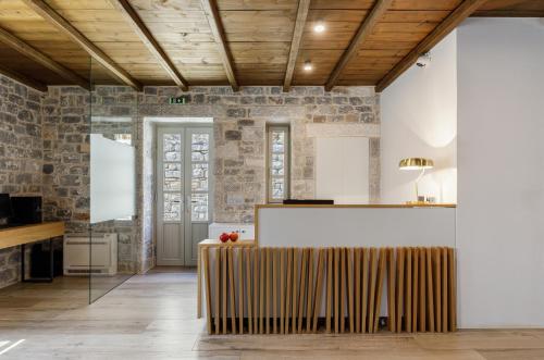 a lobby with a reception desk in a building at Trapela Limeni Luxury Suites in Limeni