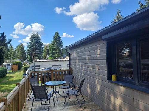 a patio with chairs and a table on a deck at Haus Zander in Lohmen