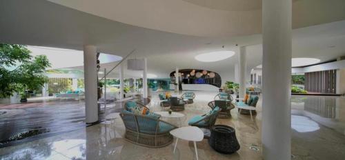 a large living room with couches and tables in it at CEBU's Best Staycation at Tambuli Seaside Living Tower C in Maribago