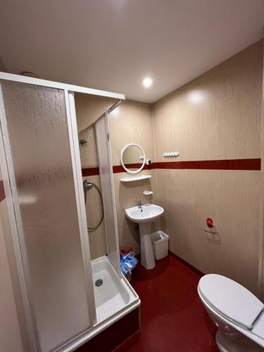 a bathroom with a shower and a toilet and a sink at O. W. BRYZA in Rowy