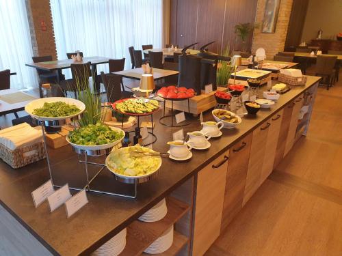 a buffet line with many different types of food at Hotel Loft 1898 in Suwałki