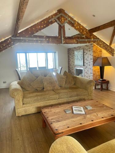 a living room with a couch and a coffee table at Beach House 3 Bed Penthouse Apartment in Southport