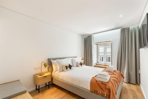 a bedroom with a large bed and a window at Dom Miguel Ap City Center By Sé Apartamentos in Braga