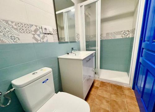 La salle de bains est pourvue de toilettes blanches et d'un lavabo. dans l'établissement Alojamiento Can Alegre, à El Perelló