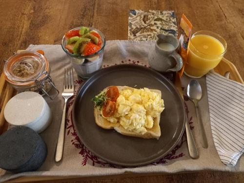 a black plate with a piece of food on a table at Hebble End View B&B in Hebden Bridge