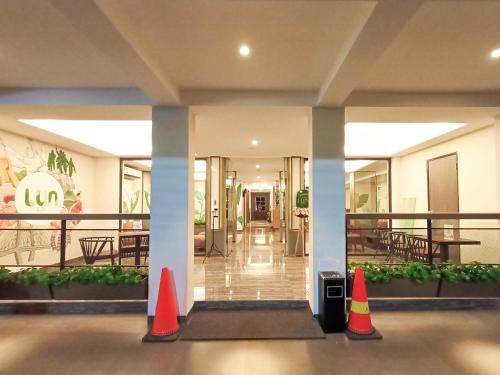 a lobby with orange cones in front of a building at Lun Hotel Manado in Manado
