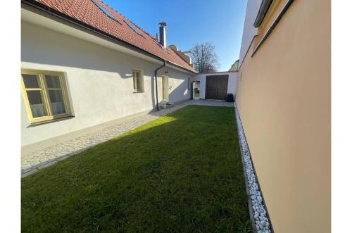 a view of a yard between two buildings at Apartmán Borovanské baroko in Borovany