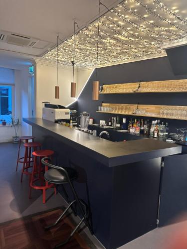 a bar in a restaurant with red bar stools at Hotel Light in Rotterdam
