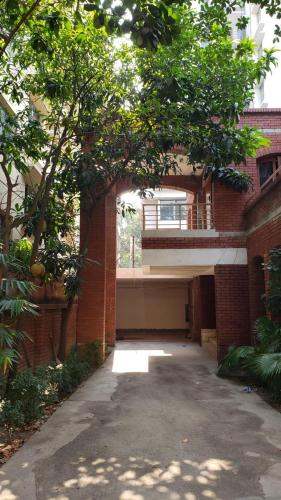 an empty parking lot in front of a brick building at Hotel Western Planet in Dhaka