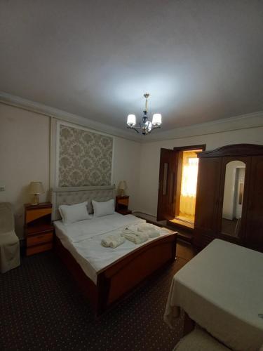 - une chambre avec un grand lit et une fenêtre dans l'établissement UYUT INN Hotel, à Samarcande