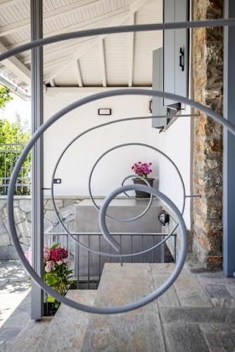 a metal gate with a staircase in a building at Afrodite's House in Glóssa