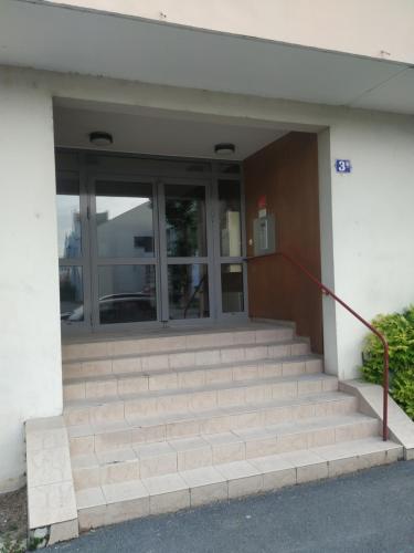 a building with stairs in front of a building at ZEN T1, 500m centre, proche gare, tout confort in Châlons-en-Champagne
