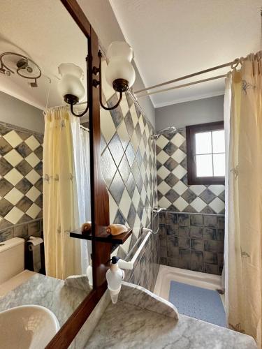 a bathroom with a sink and a mirror at Casa Horizonte in La Costa