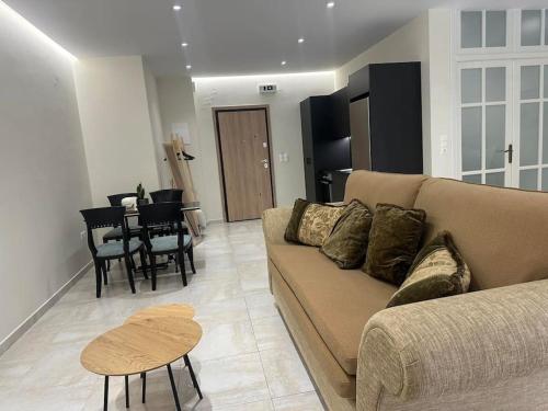 a living room with a couch and a table at Eclectic Apartment near Downtown in Heraklio