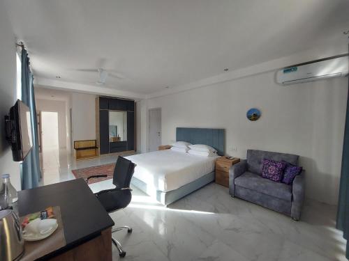 a hotel room with a bed and a chair at Areni Lodge in Areni
