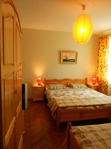a bedroom with two beds and a chandelier at Hostel Del Mar in Varna City
