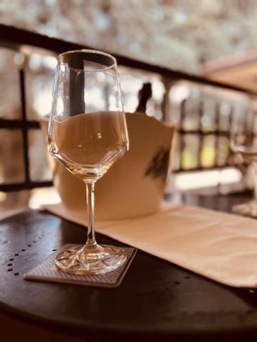 a glass of wine sitting on top of a table at Casa di Lillo in Merate