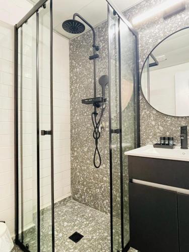 a bathroom with a shower and a sink at Haneemanim Apartments in Haifa