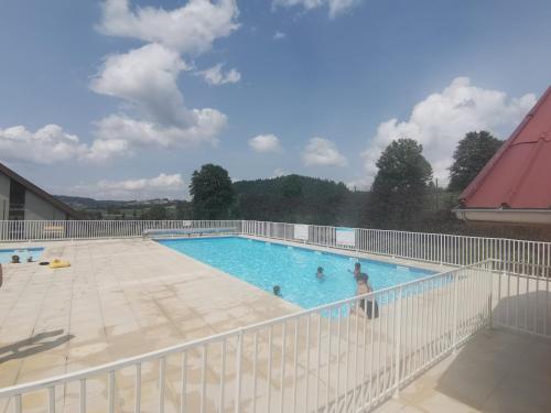 a man is standing in a swimming pool at L'échappée étoilée - Métabief in Métabief