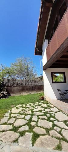 a picture of a stone walkway next to a house at LA CASA 44, con Spa opcional in Sariego